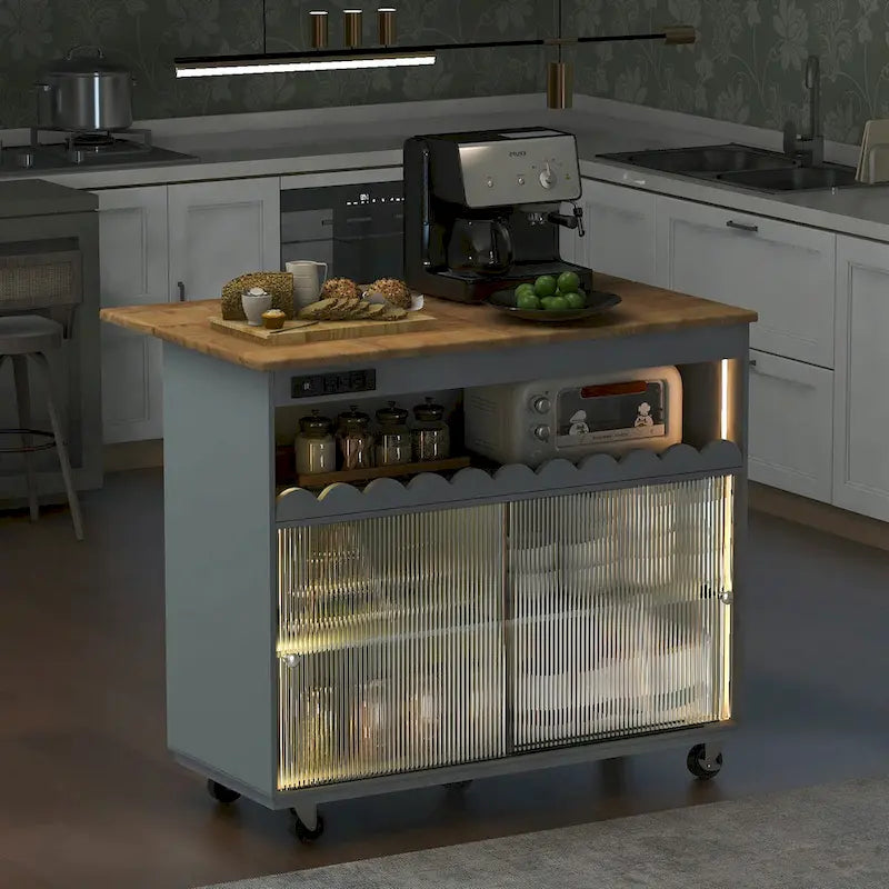 Îlot de cuisine de 112 cm de large avec dessus en caoutchouc à abattant, sur 5 roulettes, avec étagère ouverte et casier à vin